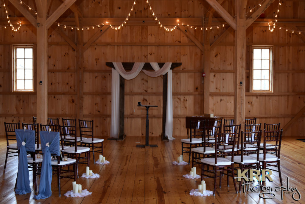 A ceremony setting inside The Barn at Pleasant Acres