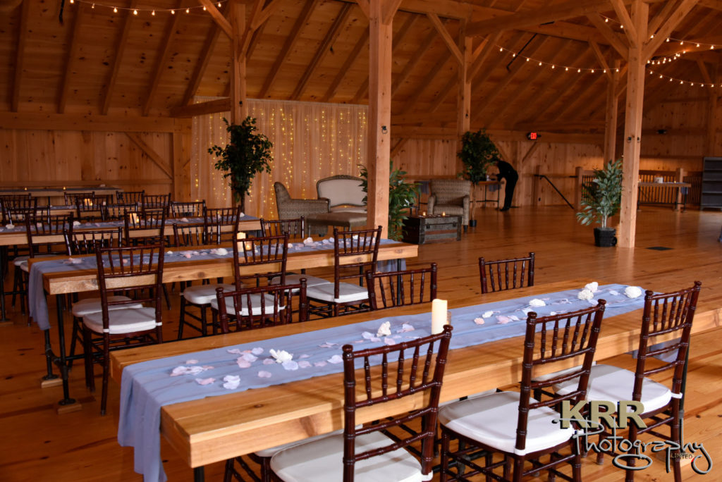 A room view with table settings at the barn at Pleasant Acres